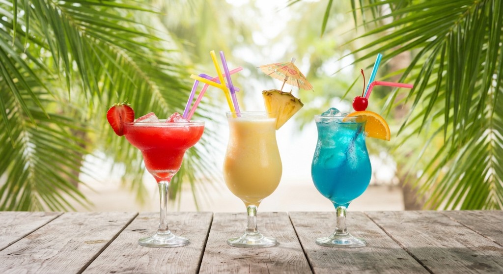 Three tropical cocktails — strawberry, piña colada, and blue hawaiian